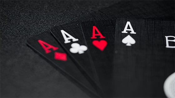 four black ace cards fanned out on a table; image used for blog post about the tax consequences when you win at gambling or betting