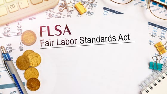 An image of a Fair Labor Standards Act (FLSA) document amidst financial documents