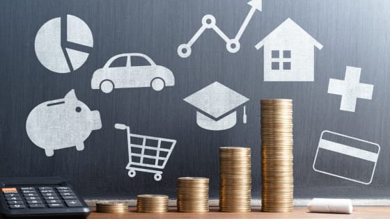 An image of a chalkboard with drawings of piggy bank, car, shopping cart, graduation cap, house; for blog post about deducting meal and vehicle expenses