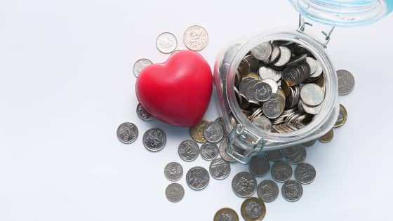 Image of a heart sitting with a jar of coins; for blog post about philanthropists