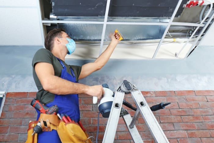 Air duct cleaning in progress by a trained professional for better air quality