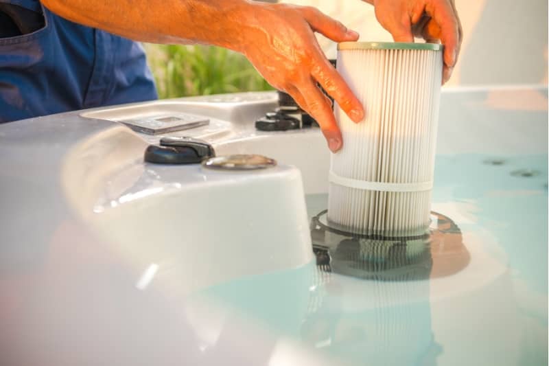 pool technician removing water filter