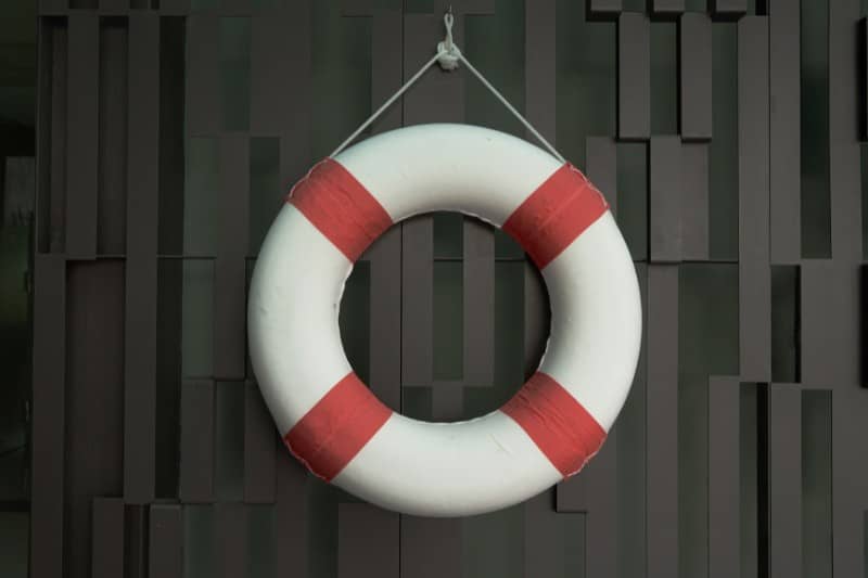 white and red lifebuoy hanged on the wall