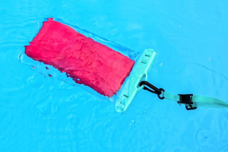 smartphone in waterproof case in pool