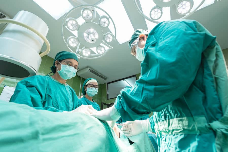 a group of surgeons performing knee surgery