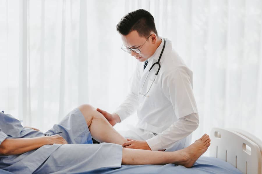 knee surgeon checking patient