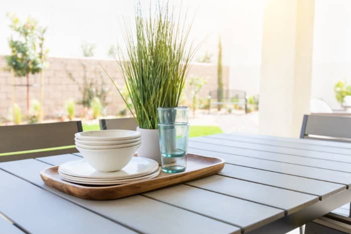 outdoor table with plates bowls and glasses